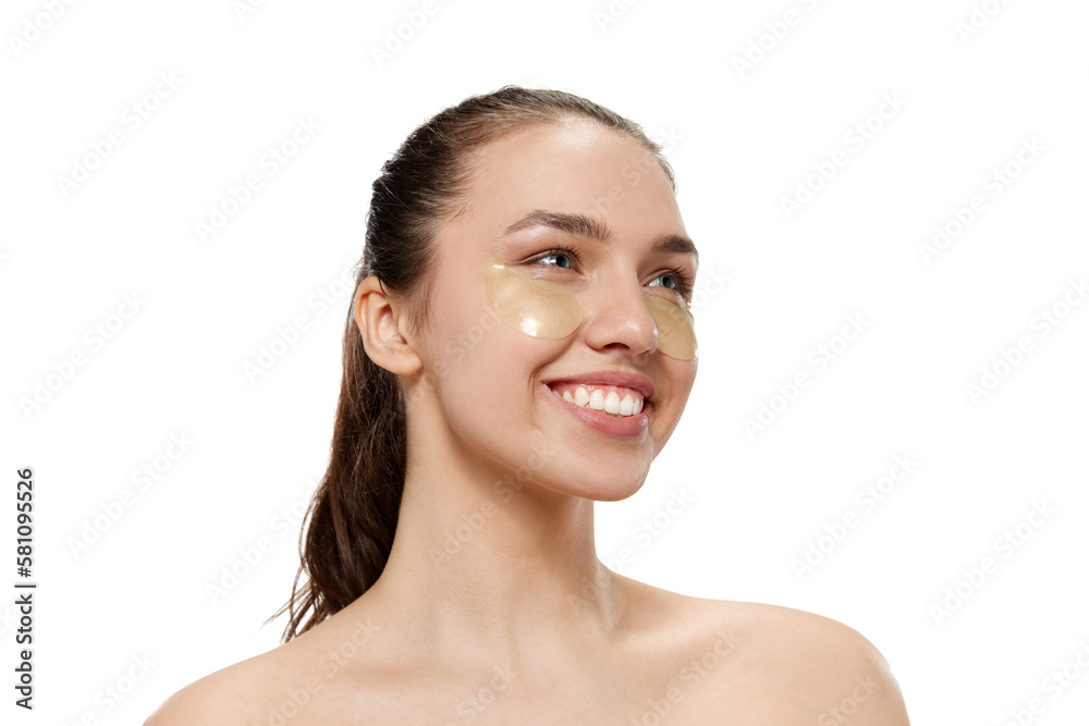 Smiling young beautiful girl with well-kept skin isolated over white studio background. Facial cosmetics masks. Concept of natural beauty, skincare, cosmetology, health, ad Smiling young beautiful girl with well-kept skin isolated over white studio background. Facial cosmetics masks. Concept of natural beauty, skincare, cosmetology, health, ad