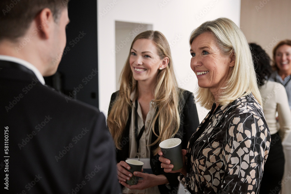 Smiling women talking during coffee break Smiling women talking during coffee break