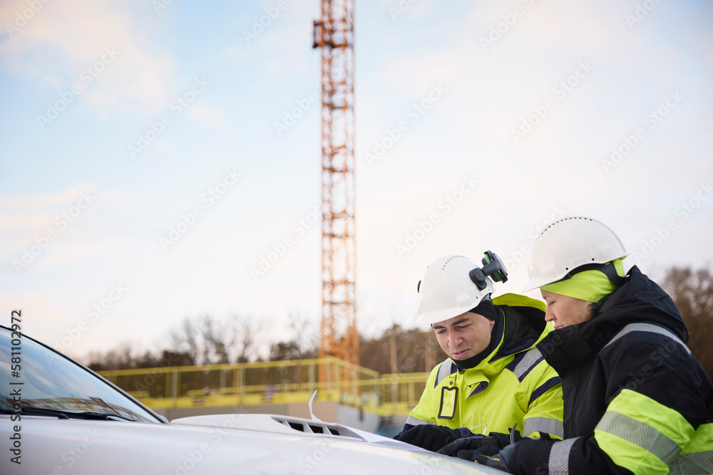 Engineers talking at building site Engineers talking at building site