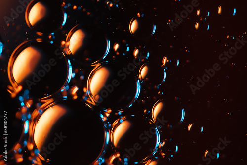 Microbubbles in mixed water and oil background, colorful abstract yellow - green led lights, super-macro abstraction