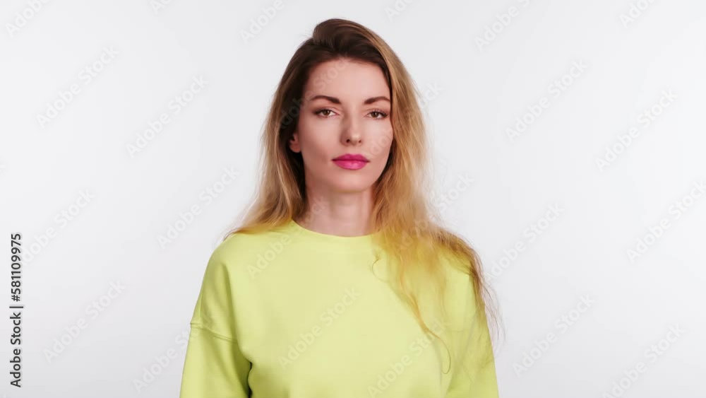 Woman showing no gesture, stop, disagreement end expression. Serious lady in yellow sweatshirt, no way ignore finish emotion. Body language concept, studio isolated on white background Woman showing no gesture, stop, disagreement end expression. Serious lady in yellow sweatshirt, no way ignore finish emotion. Body language concept, studio isolated on white background