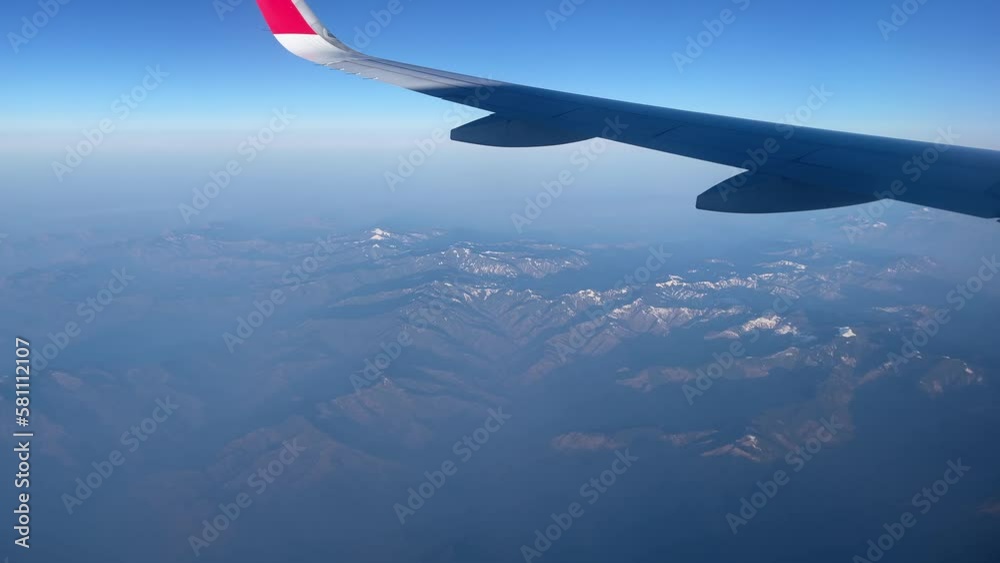 View from airplane window with beautiful blue sky.