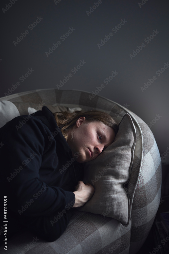 Sad man facing depression lying in bed Sad man facing depression lying in bed