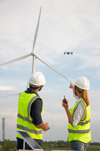 engineer team working in wind turbine farm. Renewable energy with wind generator by alternative energy concept.