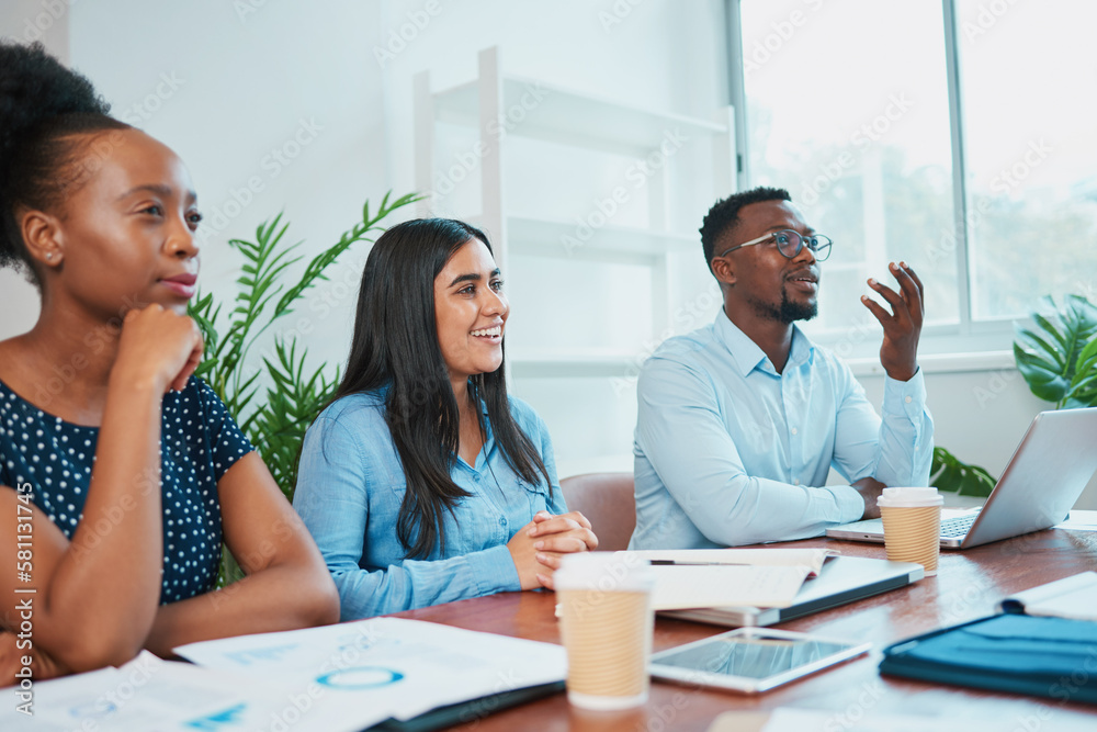 Fototapeta premium Three colleagues in business meeting around conference table, discuss solutions