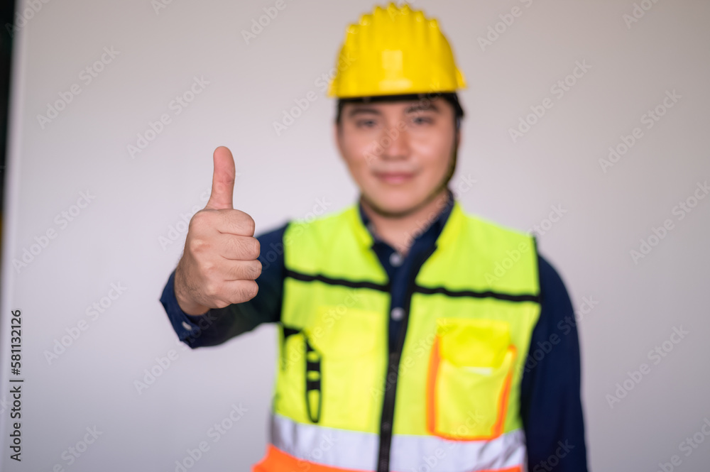 Asian people are engineer standing, Building sector and industrial workers concept. Confident young asian engineer, construction manager in reflective clothes and helmet,