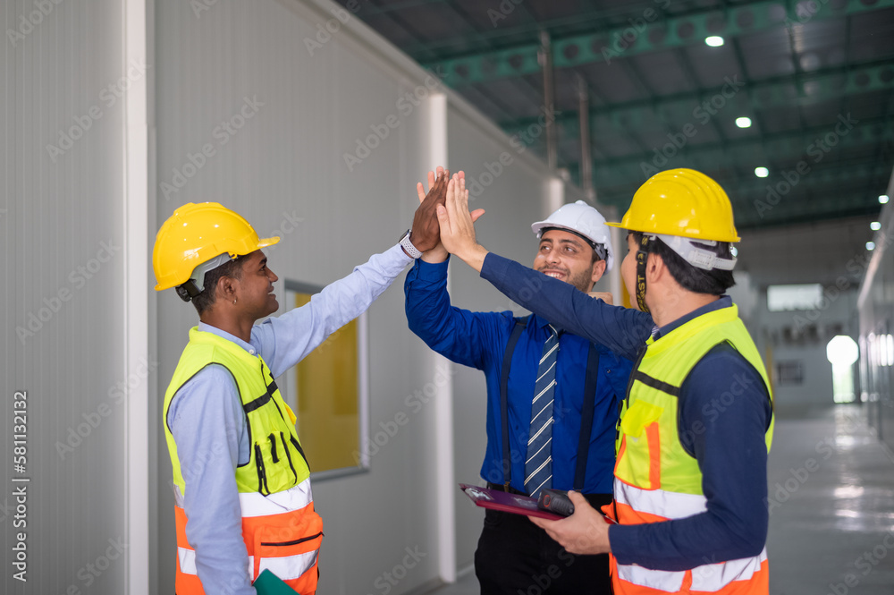 Group of business people Happy successful multiracial business team giving a high fives gesture as they laugh and cheer their success