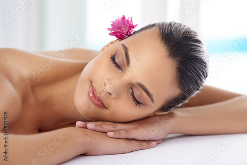 Self care is a divine responsibility. a beautiful young woman relaxing during spa treatment.