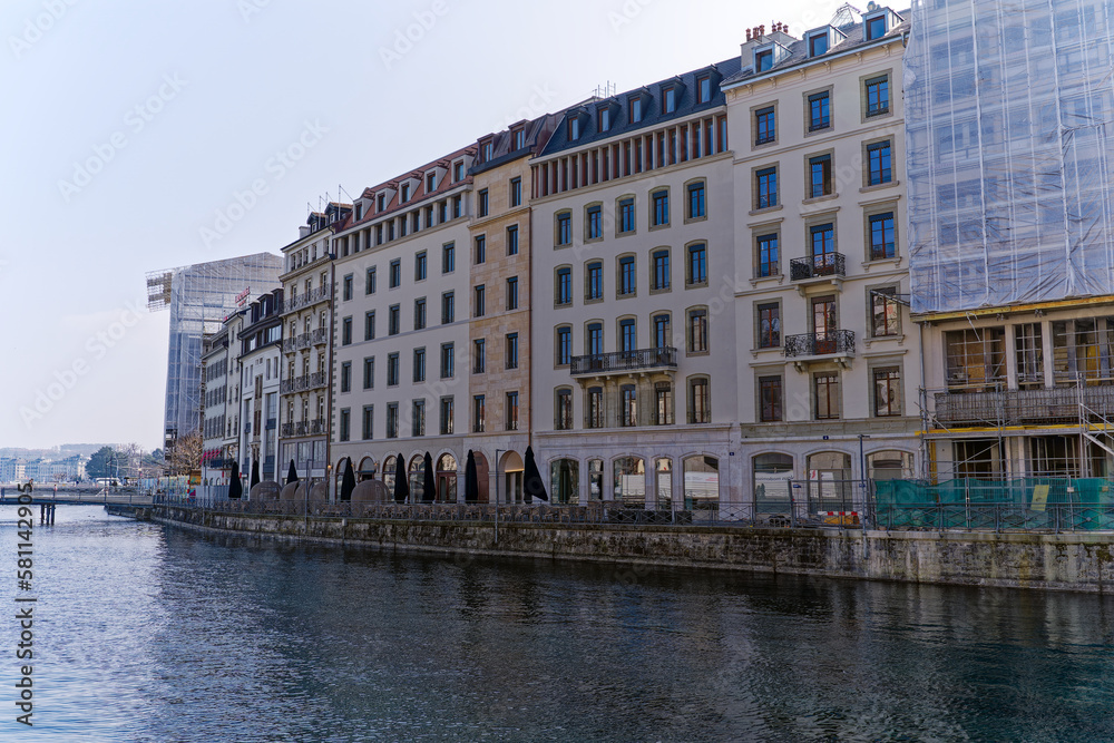 Rhone River scenic view of facades at Swiss City of Geneva on a sunny winter day. Photo taken March 5th, 2023, Geneva, Switzerland.