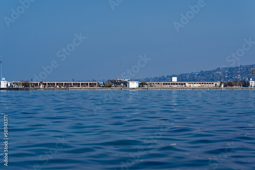Bath at Lake Geneva named Bains de Pâquis at Swiss City of Geneva on a sunny late winter day. Movie shot March 5th, 2023, Geneva, Switzerland.