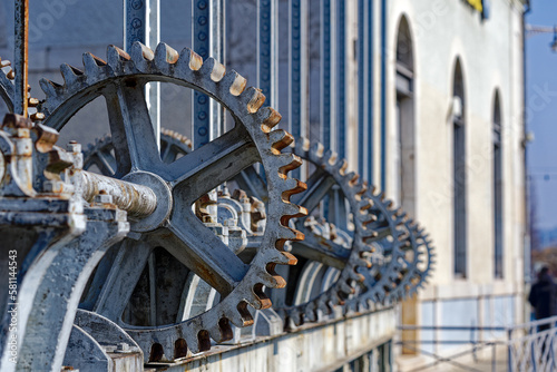 Waterfront at Swiss City of Geneva with close-up of cog wheels at Rhone River on a sunny late winter day. Photo taken March 5th, 2023, Geneva, Switzerland.