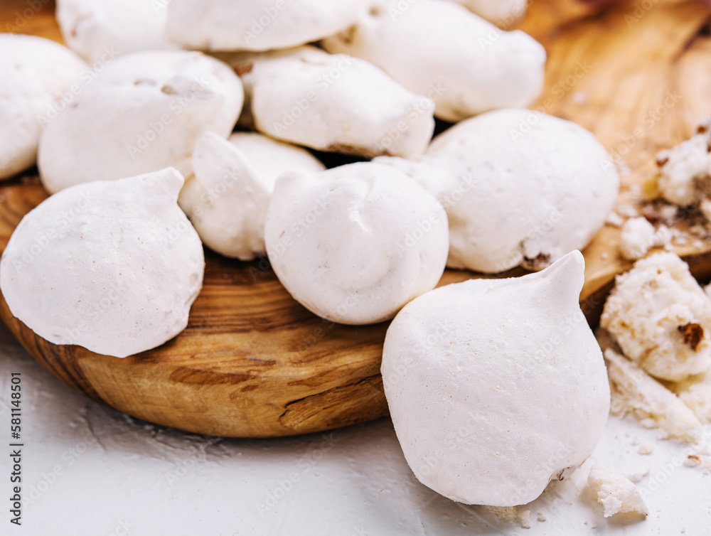 Fresh meringue cookies on wooden board Fresh meringue cookies on wooden board