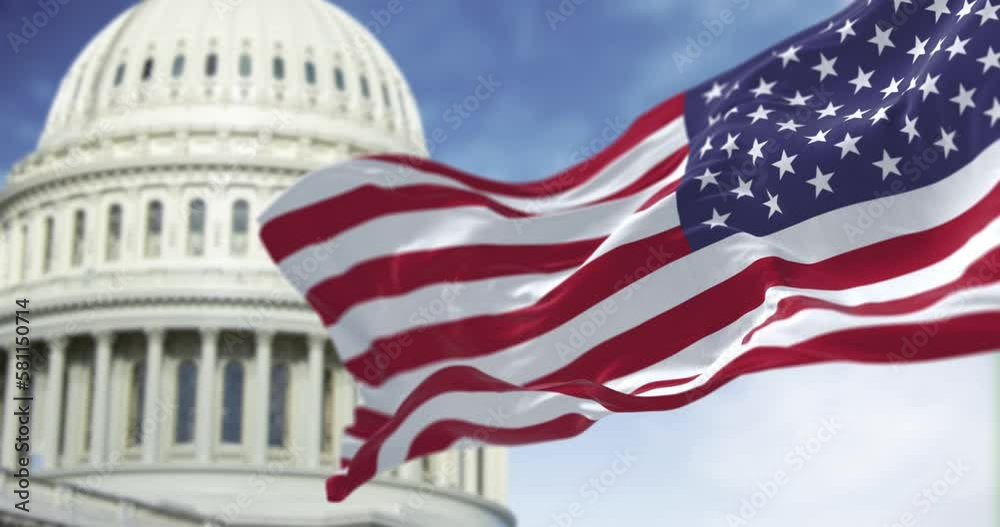 Seamless loop in slow motion of US flag waving in the wind with the American US Capitol in the background