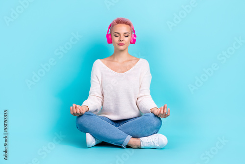 Full body size cadre of meditation practicing youngster attractive girl carefree listen yoga music playlist isolated on aquamarine color background