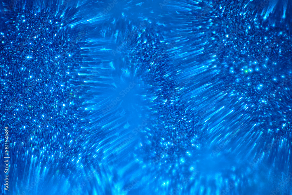 Fototapeta premium Abstract blue background with blurred shiny shapes.