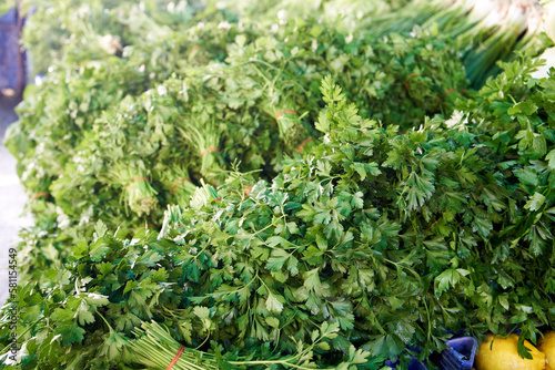 Fresh parsley and other green herbs being sold at the farmers market