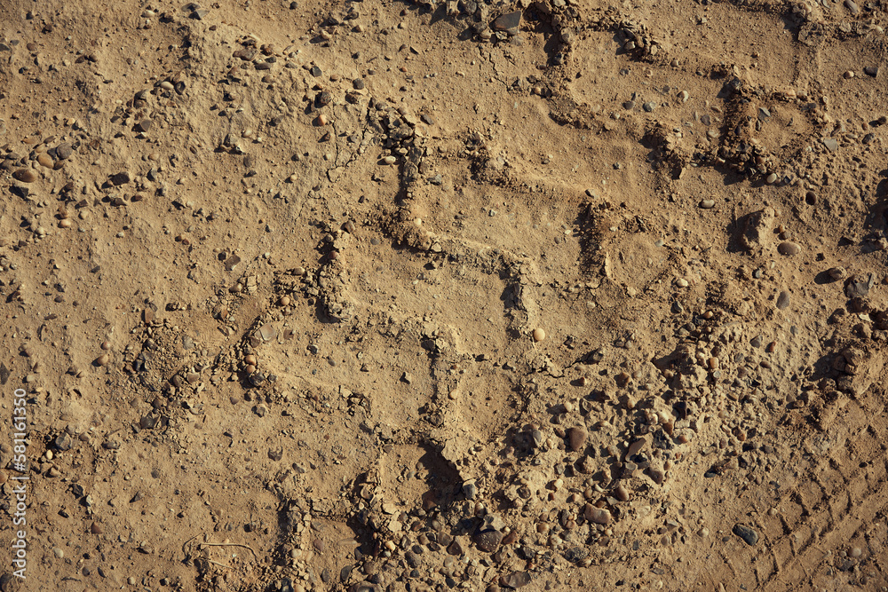 Dirt gravel road with tire tracks texture at the construction site