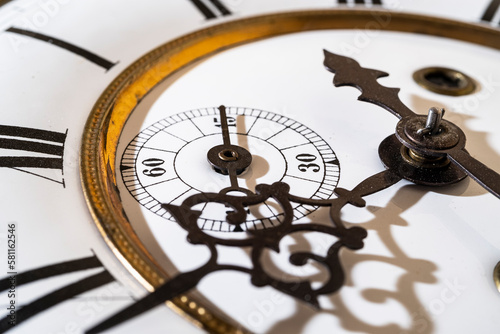 Old wooden clock with a pendulum hanging on the wall	