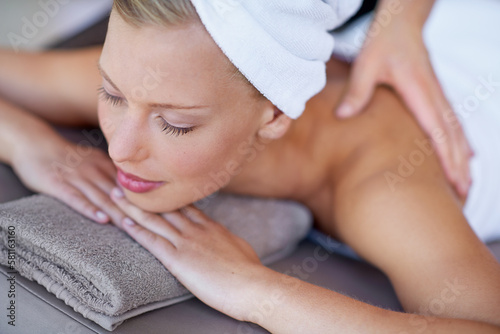 Her masseuse has magical hands. a young woman enjoying a spa massage.