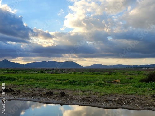 Mountains  cloudds  and green land