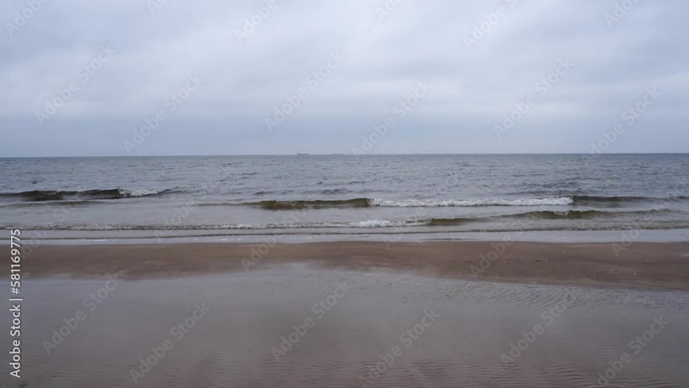 Slow motion video of the sea waves washing the shore on a cloudy day Slow motion video of the sea waves washing the shore on a cloudy day