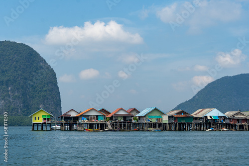 Houses on stilts in the sea in thailand against the backdrop of the islands