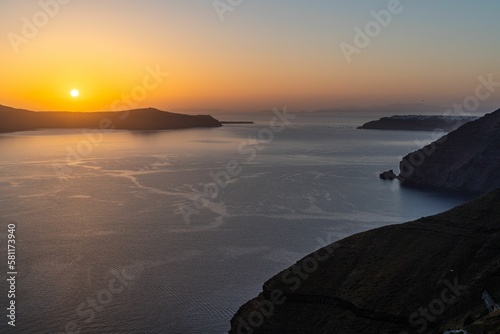 Amazing landscape with a beautiful sunset on Thirasia island viewed from Santorini, Greece photo