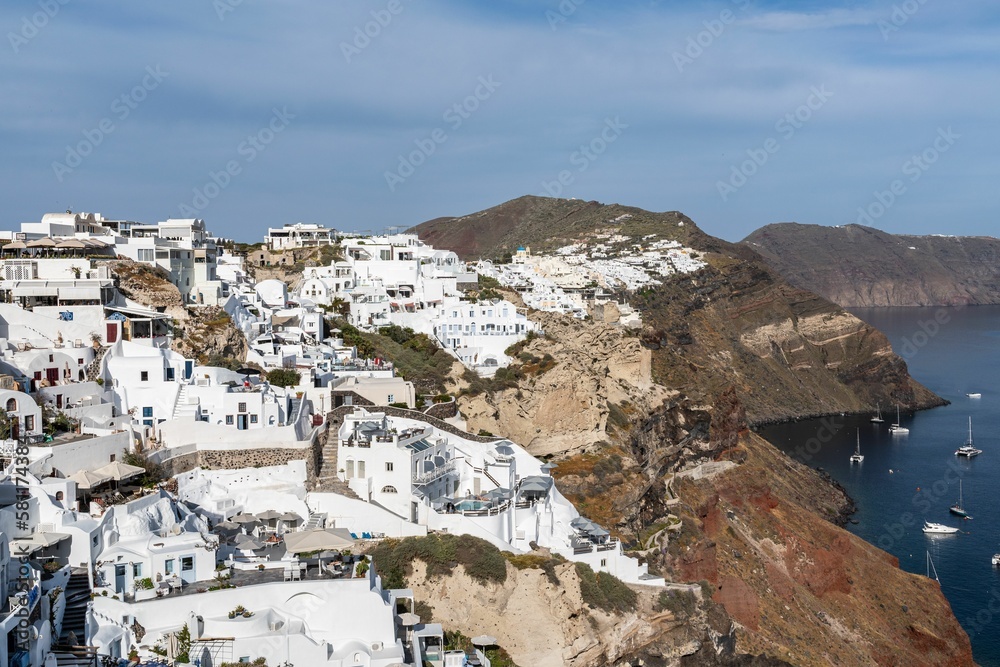 Beautiful view of whitewashed buildings and the coast in Oia, Santorini, Greece.