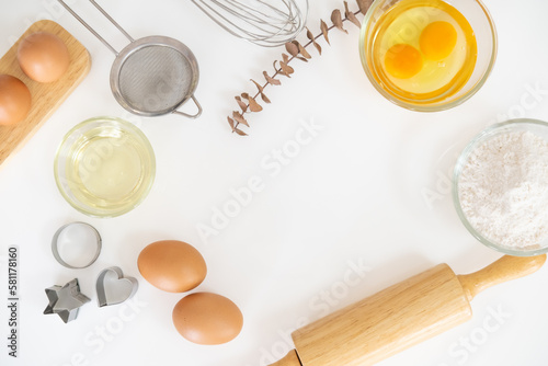 Baking Cooking Ingredients Flour Eggs Rolling Pin Butter And Kitchen Textile On white mable Background. Top View Copy Space. Cookies Pie Or Cake Recipe Mockup