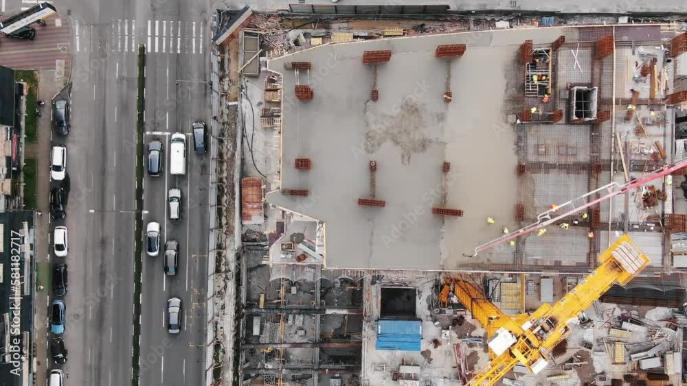 Top down view of construction site with construction cranes Top down view of construction site with construction cranes