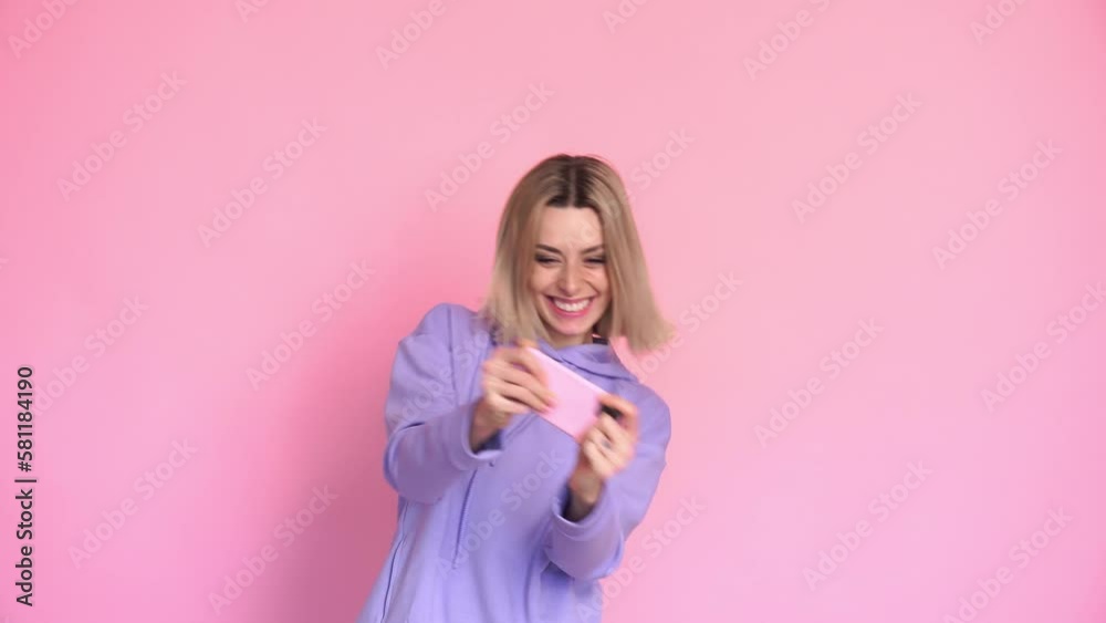 Smiling woman playing games with her smartphone Smiling woman playing games with her smartphone