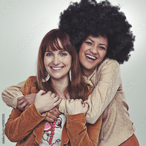 Soul sisters. Cropped studio portrait of two girl friends in retro style outfits.