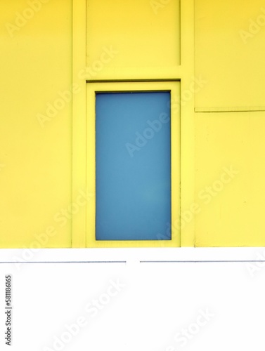 Yellow building with blue window