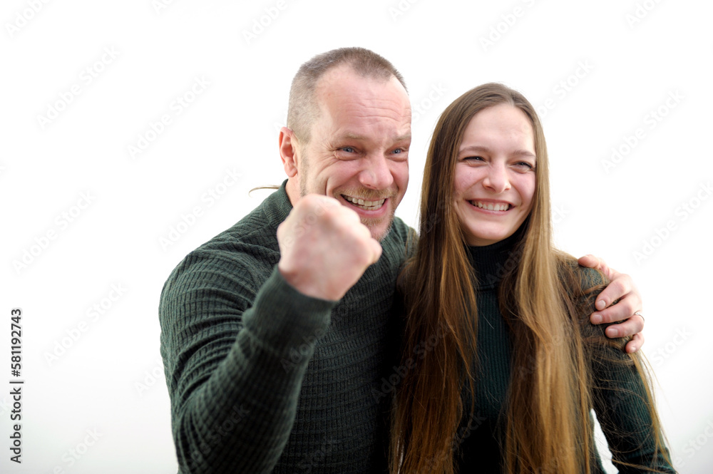 Victory win very satisfied faces of adult man and young woman he hugs girl clenched fist with joy shows we won Our victory on white background result of game football match end of project successful Victory win very satisfied faces of adult man and young woman he hugs girl clenched fist with joy shows we won Our victory on white background result of game football match end of project successful