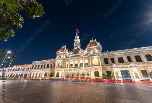 Traffic in front of Ho Chi Minh City Hall, Saigon City Hall or Committee Head office in the evening, Vietnam. Light trail and night. Popular place to visit in Saigon photo
