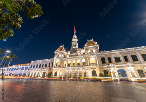 Traffic in front of Ho Chi Minh City Hall, Saigon City Hall or Committee Head office in the evening, Vietnam. Light trail and night. Popular place to visit in Saigon photo