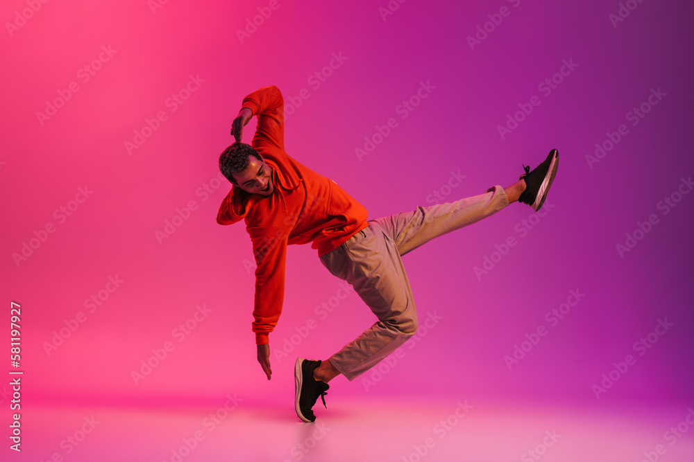 African man dancing isolated isolated over pink neon studio background