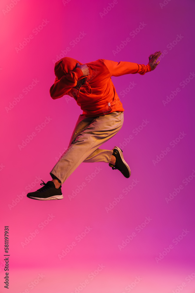 African man jumping high isolated over pink background