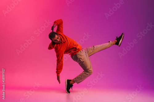 African man dancing isolated isolated over pink neon studio background