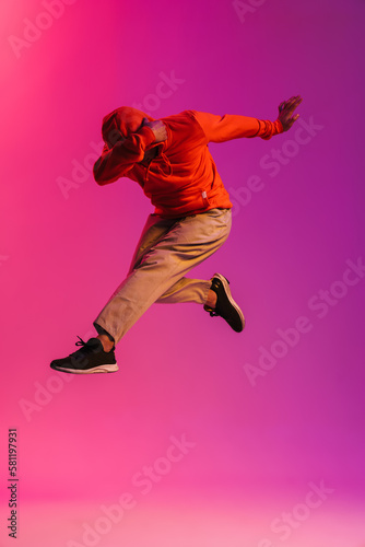 African man jumping high isolated over pink background