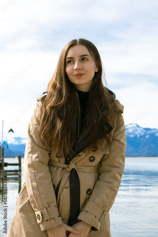 Girl near the mountain lake.Woman near the lake in the mountains.Alpine landscape.Portrait in the Alps.Recreation in nature.Tourist in the mountains.Snow on the top of the mountain.Woman traveler.Love