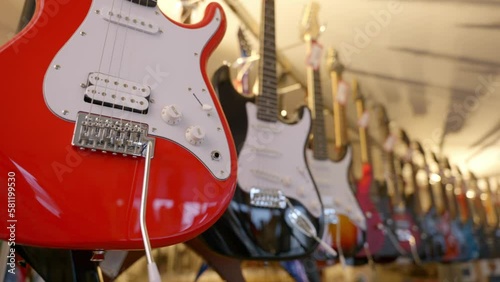 a lot of vintage electric guitars in the interior of a music store