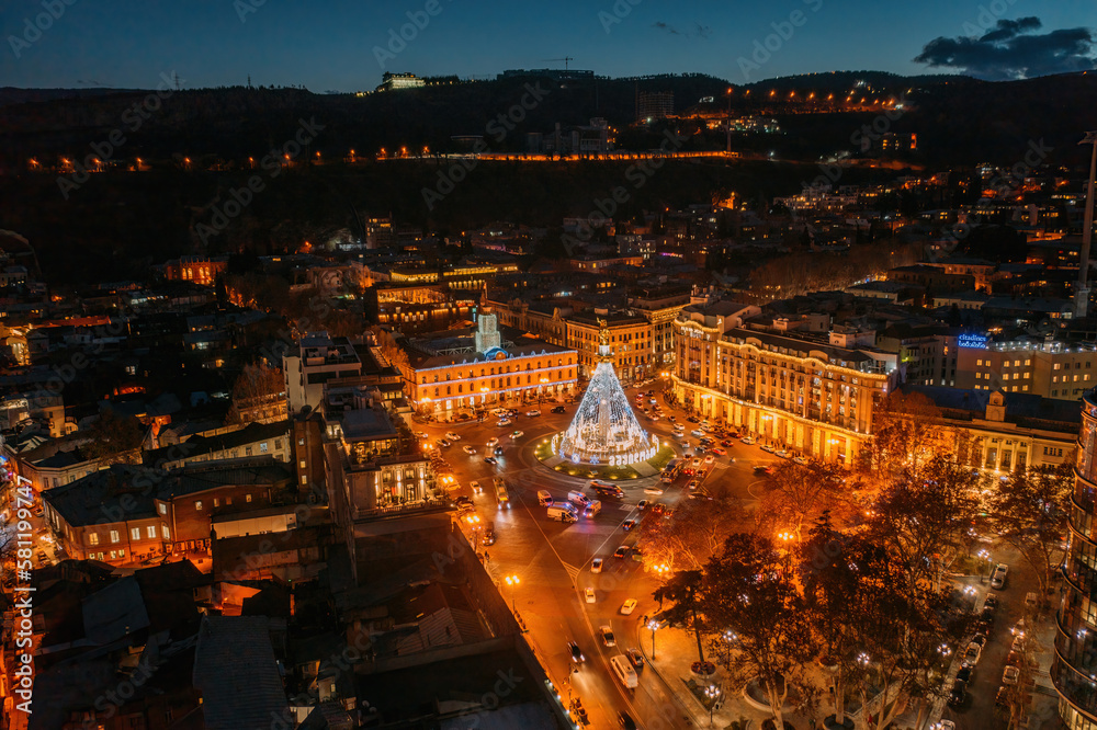 Panoramic night aerial view of Tbilisi, capital of Georgia from drone. Liberty square
