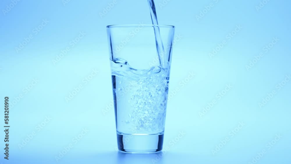 Pure Water Poured Into Glass in slow motion Closeup Pure Water Poured Into Glass in slow motion Closeup