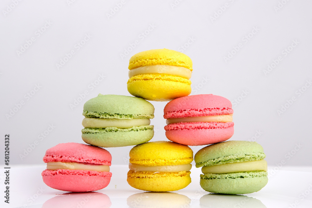Close up of colorful macarons cakes. Small French cakes. Sweet and colorful dessert with vintage pastel tones. . High quality photo Close up of colorful macarons cakes. Small French cakes. Sweet and colorful dessert with vintage pastel tones. . High quality photo