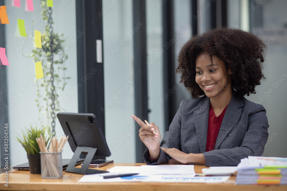 Young African American businesswoman working with pile of documents at office workplace, business finance and accounting concepts. Young African American businesswoman working with pile of documents at office workplace, business finance and accounting concepts.