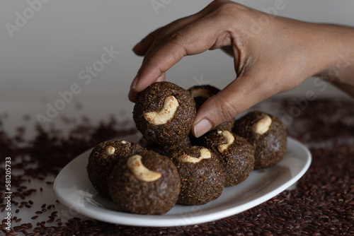 Poongar rice laddu. A healthy snack or ladoo made of poongar rice, jaggery and freshly grated coconut. A recipe with no ghee, no oil and no sugar photo