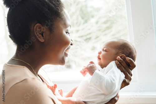 A Portrait of a beautiful black mother, with her nursing baby