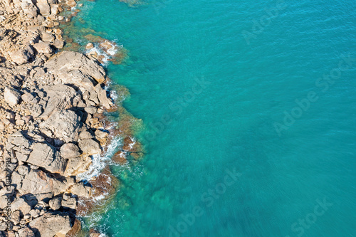 Stunning Aerial View of Mediterranean Blue Waters and Stone Cliffs - A Breathtaking Coastal Landscape