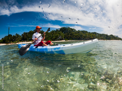 woman kayaking in clear tropical sea summer fun
